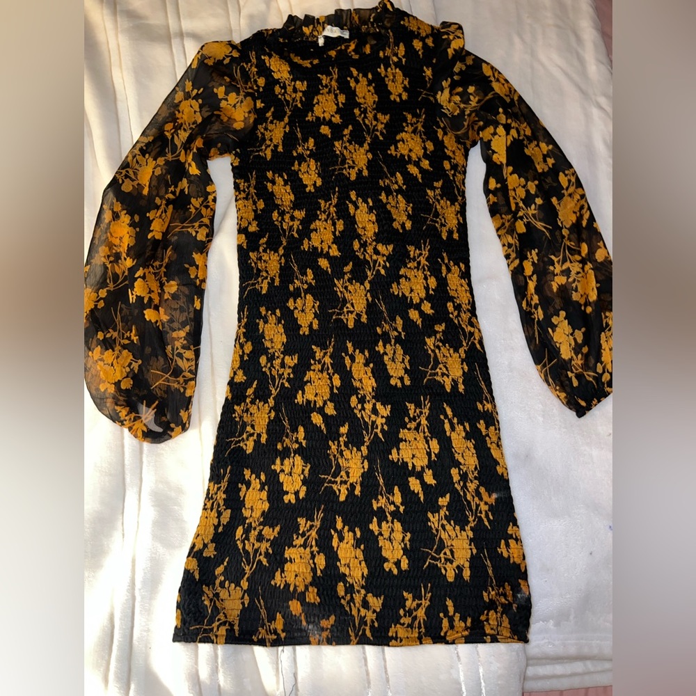 Tight orange and black flower pattered dress with mesh sleeves.Size M Never worn